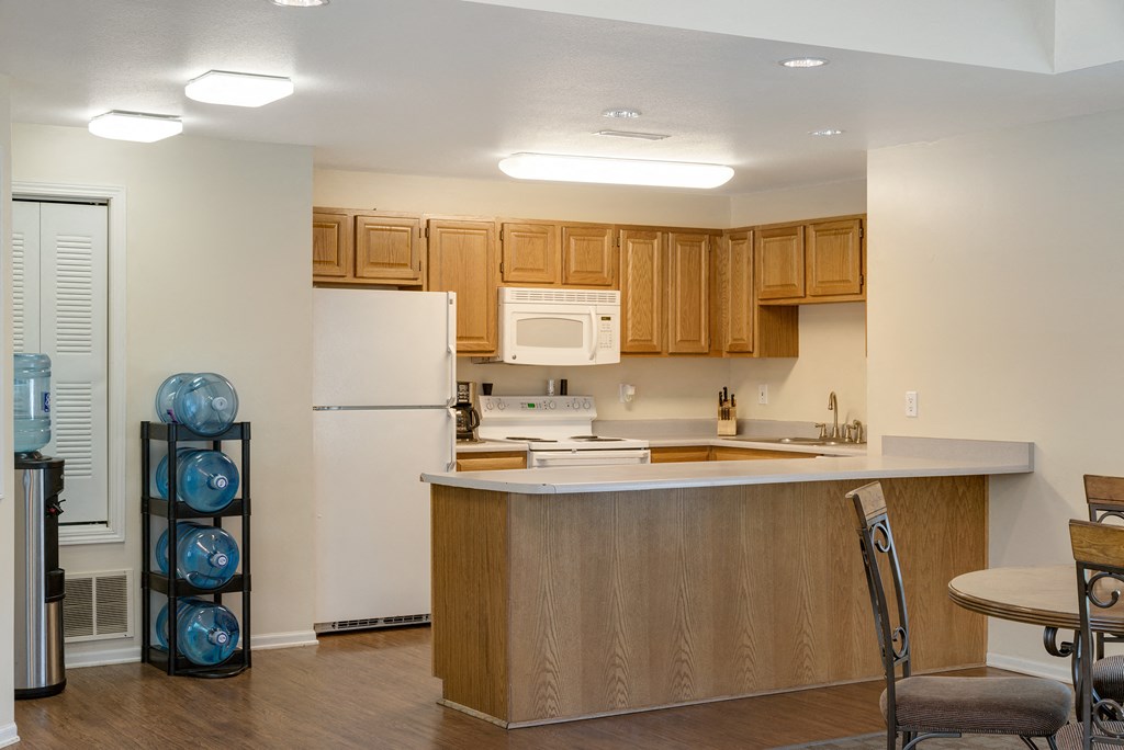 a kitchen with an island and a white refrigerator
