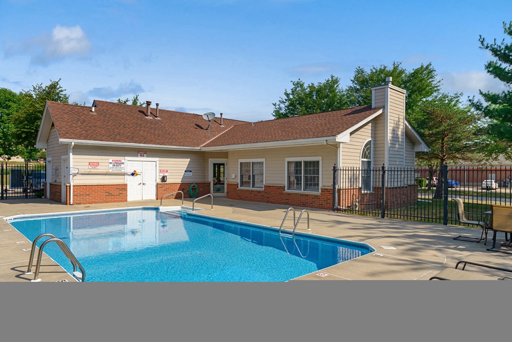 a swimming pool in front of a house