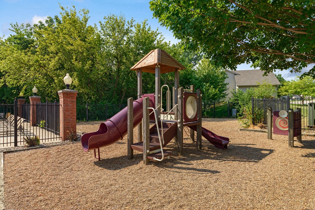 a playground with a slide and other toys in a park