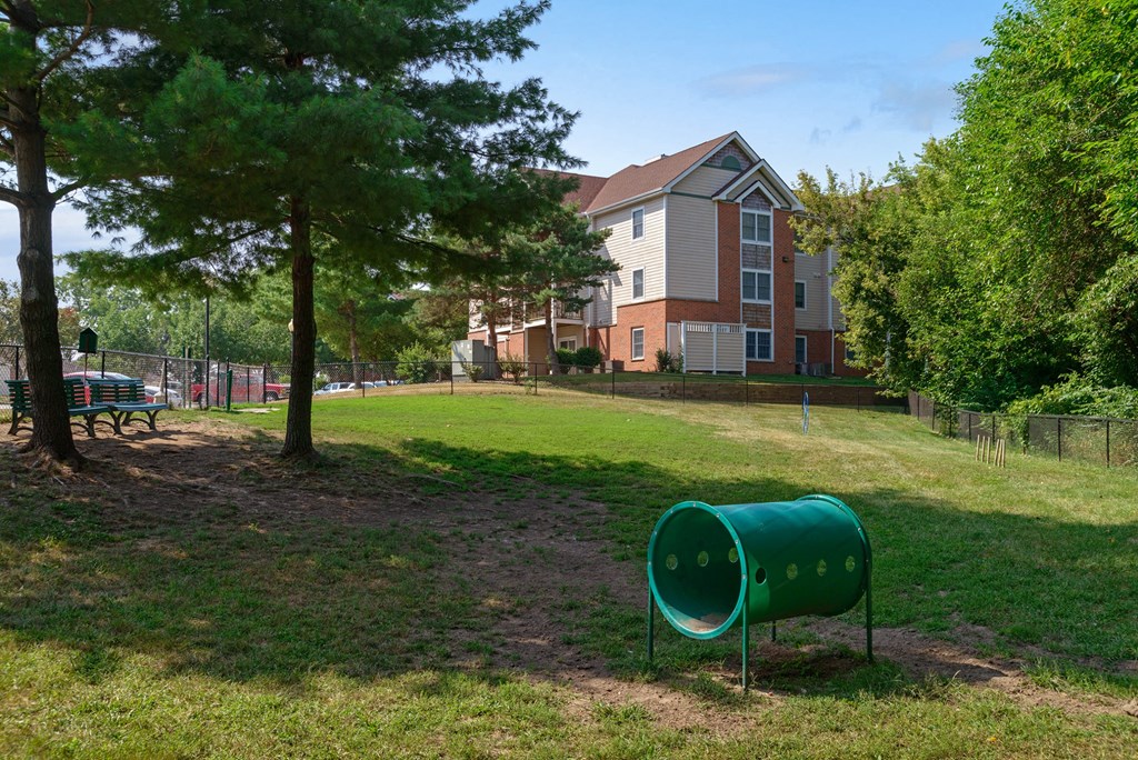 a green park with a building in the background