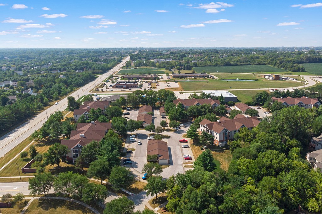 an aerial view of a neighborhood with houses and a highway