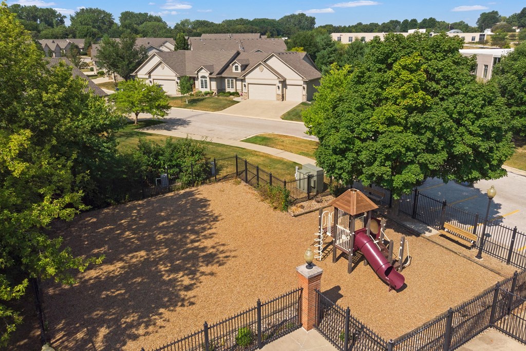 an aerial view of a playground in a neighborhood with a swing set