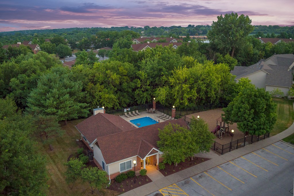 an aerial view of a house with a swimming pool and a yard