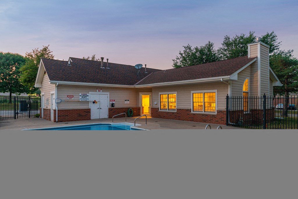 a house with a pool in the yard at dusk