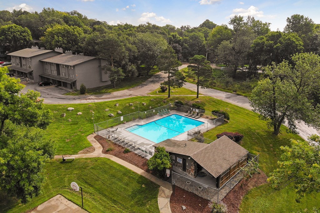 a backyard with a swimming pool and a house