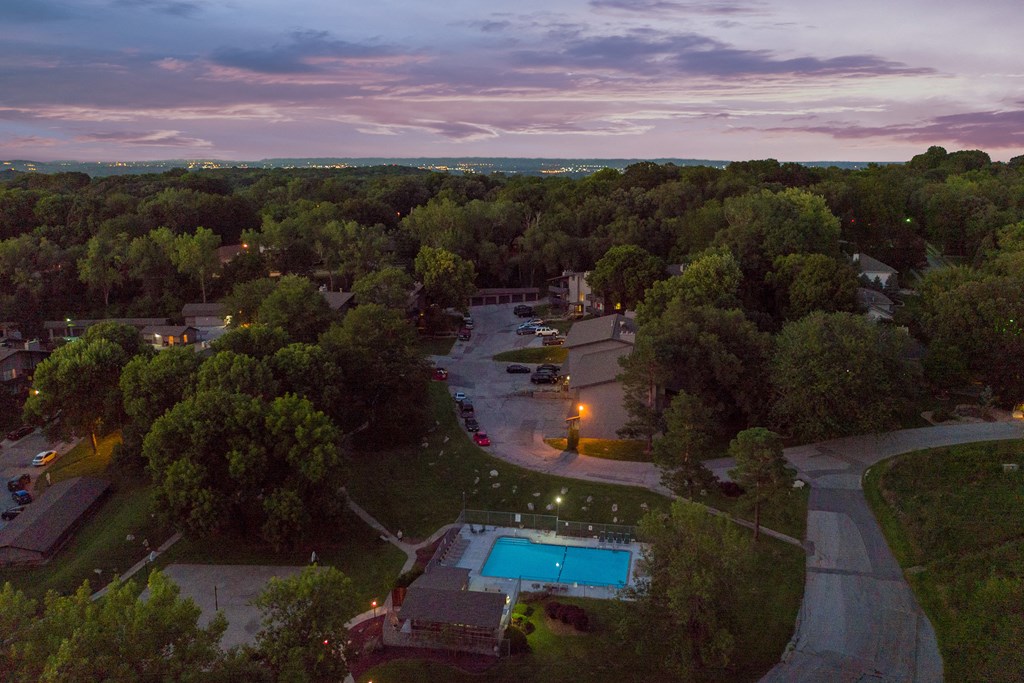 a aerial view of a park and a swimming pool at dusk