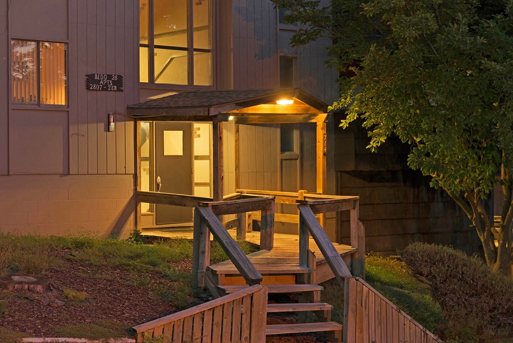 the porch of a home is lit up at night
