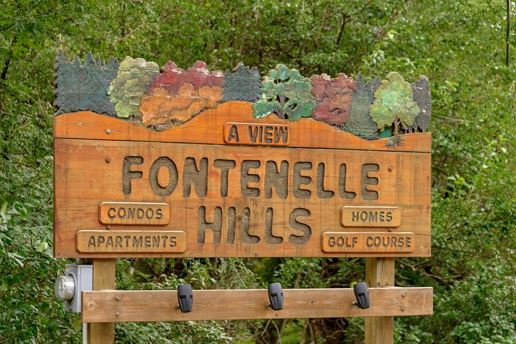 a wooden sign for fountain hills apartments and condos