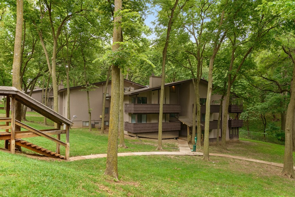 a house in the woods with trees around it