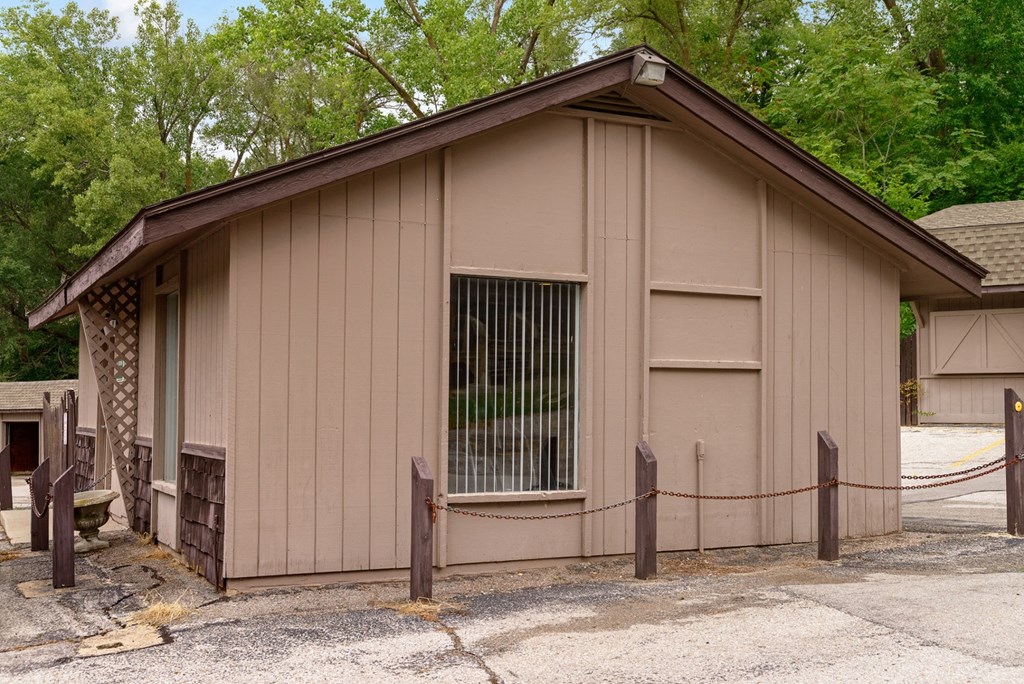 a small building with a gate on the side of it