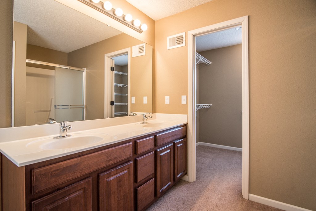 an empty bathroom with a large mirror and a sink