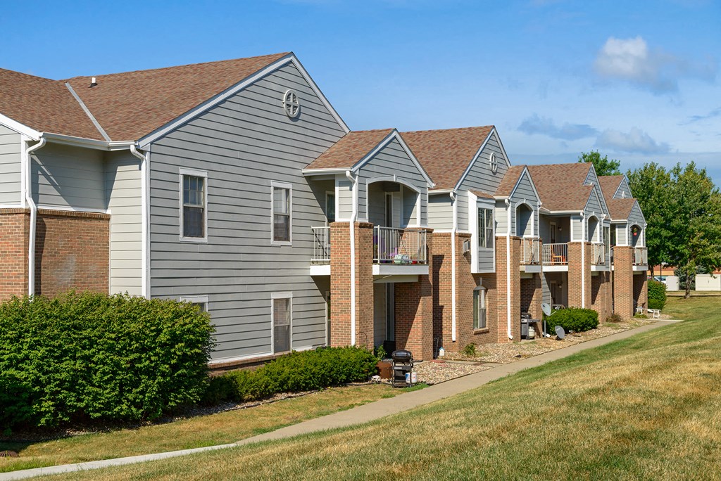 a row of houses with brick and gray siding