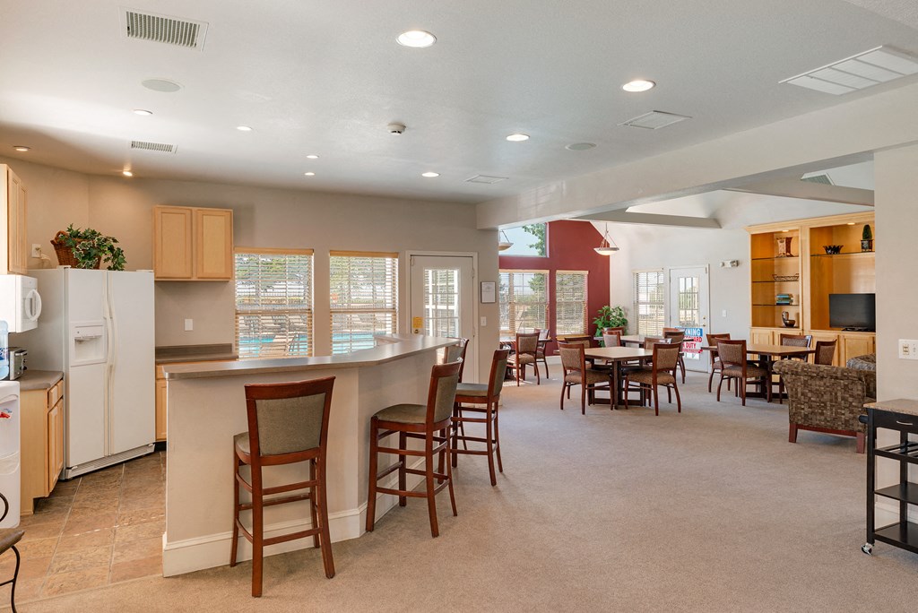 a community room with a kitchen and dining area