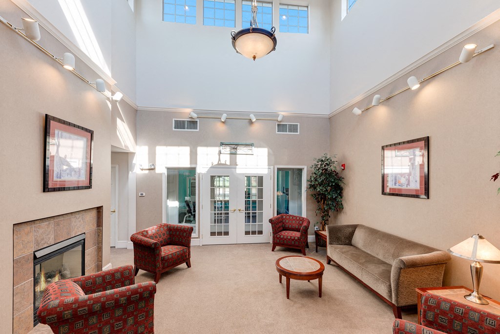a living room with couches and chairs and a fireplace