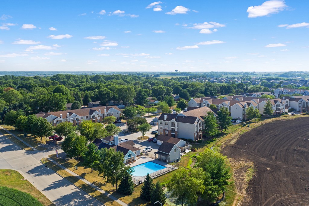 an aerial view of a neighborhood with houses and a swimming pool