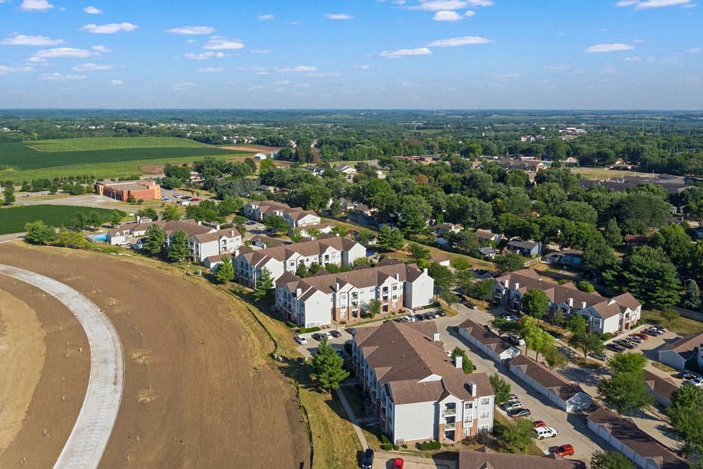 an aerial view of a neighborhood with houses and a dirt road