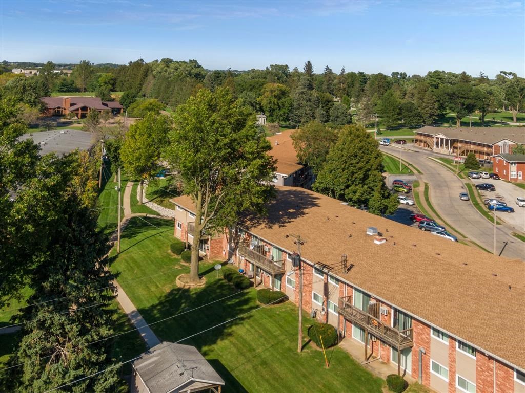 a view of a building from above with a street and trees