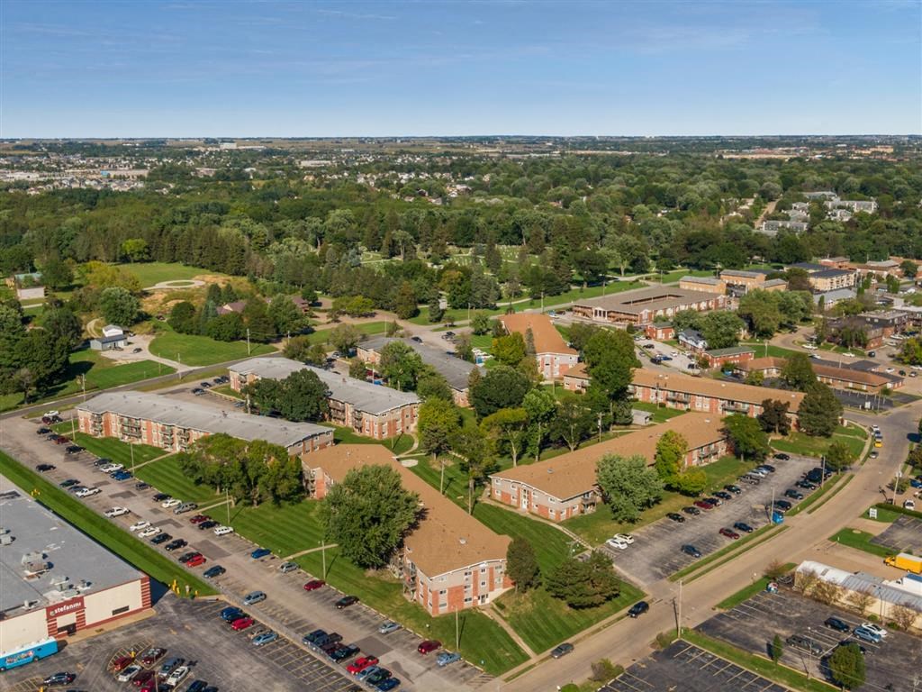 an aerial view of the parking lot of an apartment complex