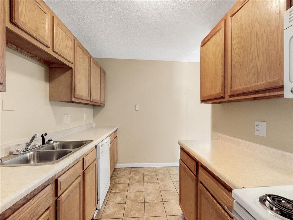 a kitchen with wooden cabinets and a sink