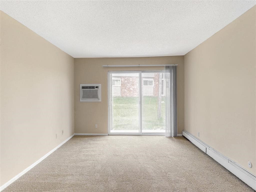 an empty living room with a sliding glass door