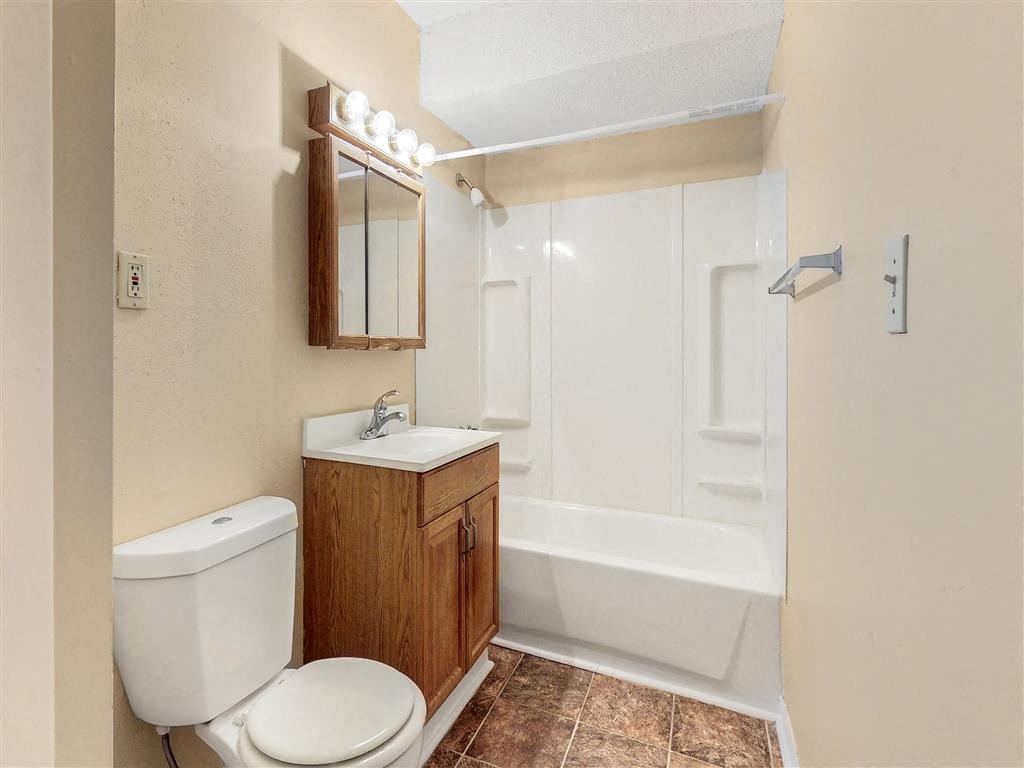 a bathroom with a toilet and a sink and a shower