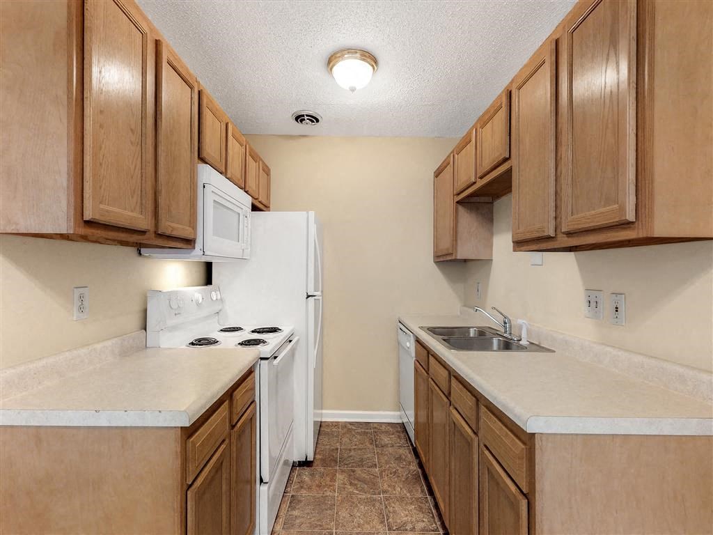 a kitchen with a stove refrigerator and sink