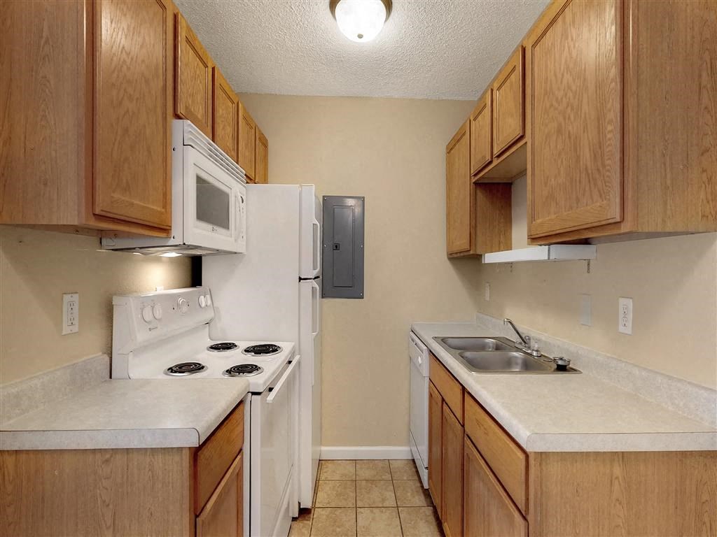 a kitchen with a stove microwave and a sink