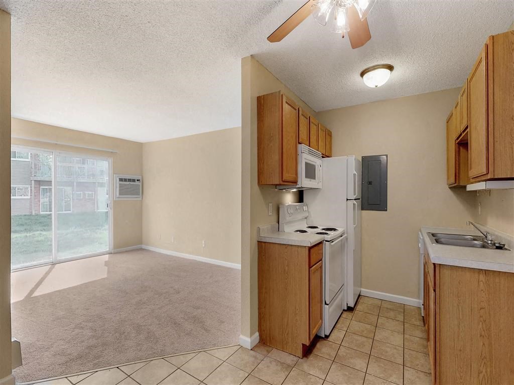a kitchen with a stove refrigerator and a sink