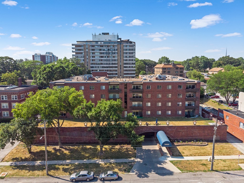 an aerial view of a red brick building with a blue tunnel