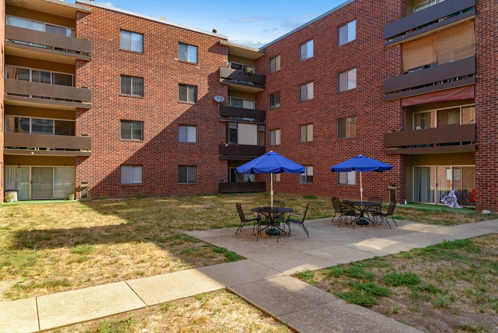 our apartments have a large courtyard with tables and umbrellas