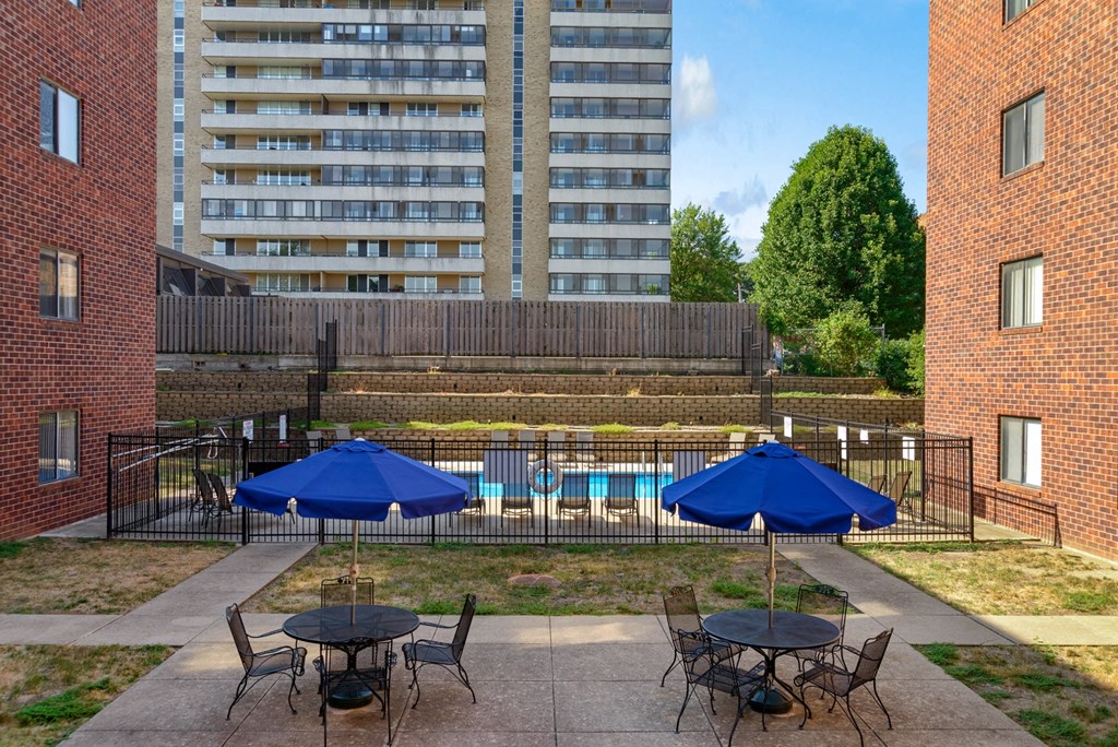 our apartments have a large patio with tables and umbrellas