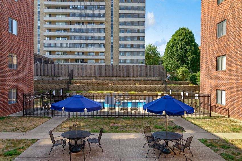 our apartments have a large patio with tables and umbrellas