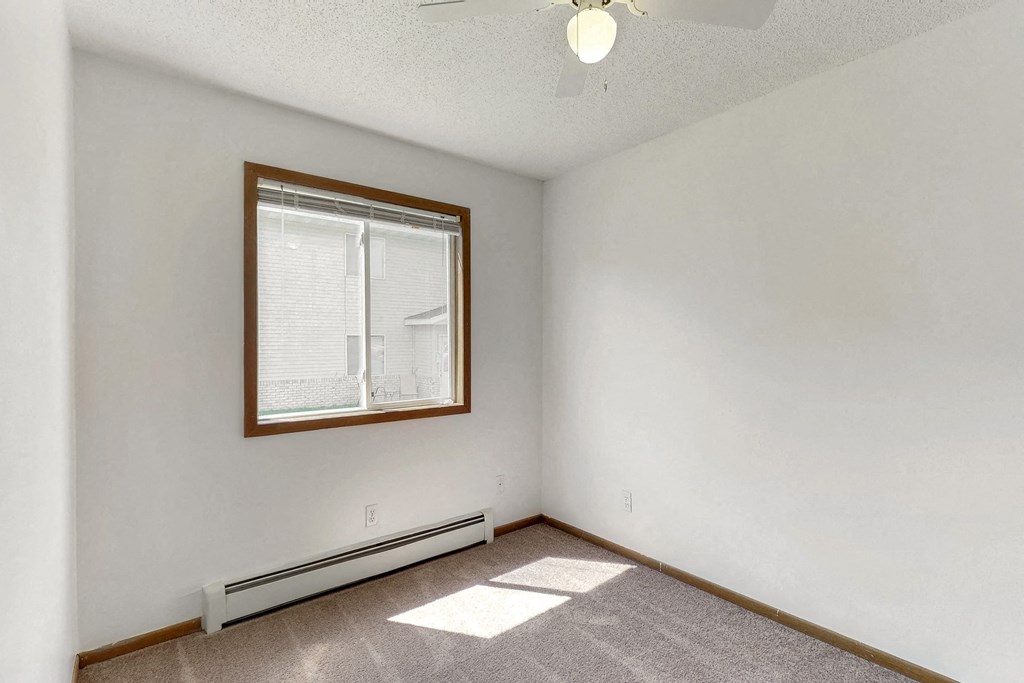 the living room of an empty house with a window
