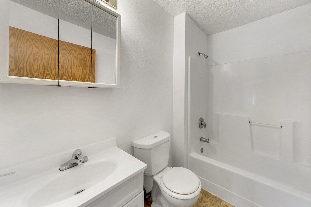 a bathroom with a sink toilet and a tub