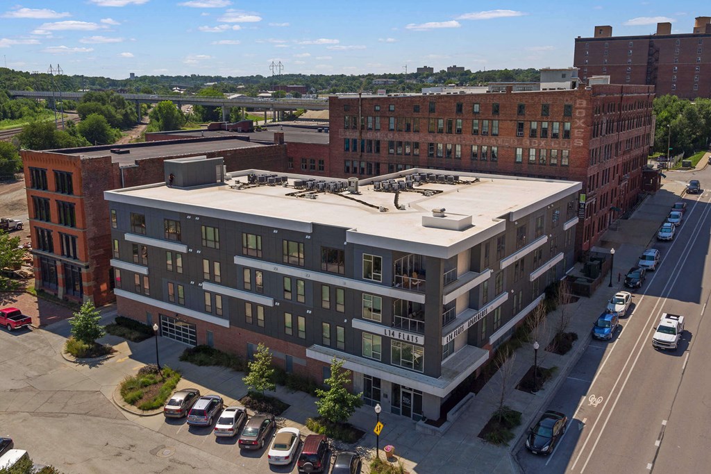 an aerial view of a building with a roof on top