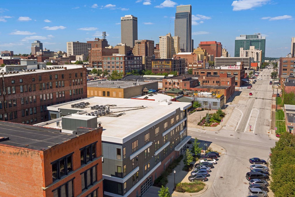 an aerial view of the city with a building with a white roof