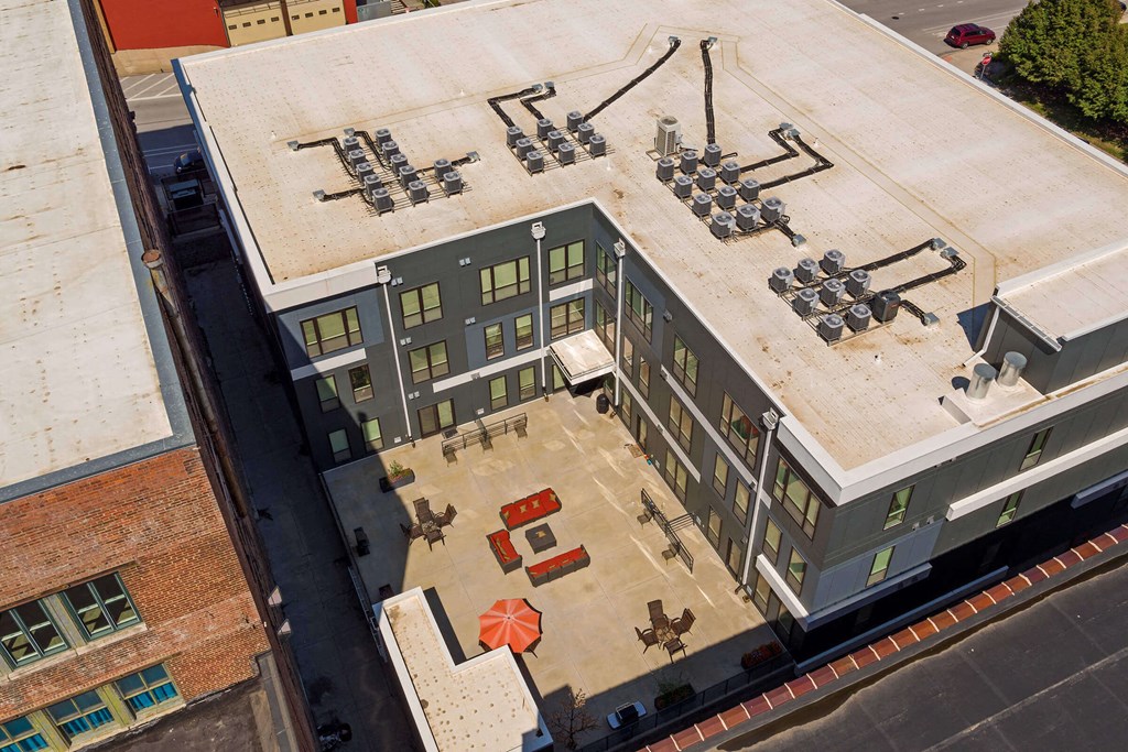 an aerial view of a building with a parking lot