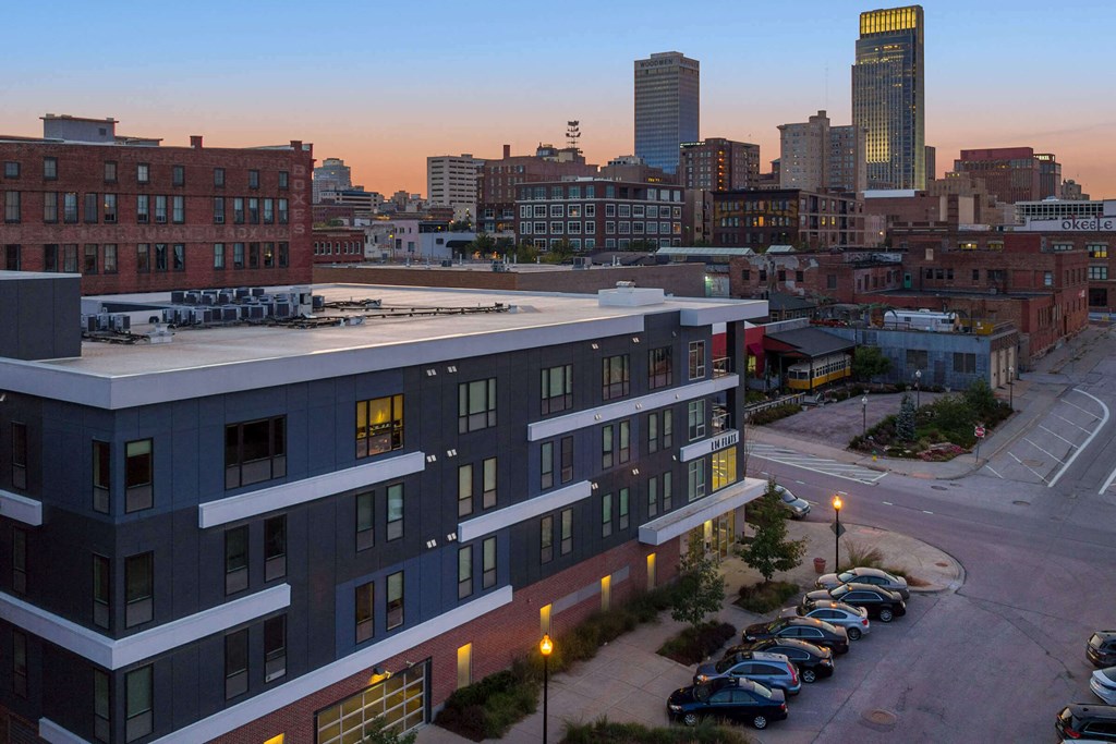 an aerial view of a building with a city in the background
