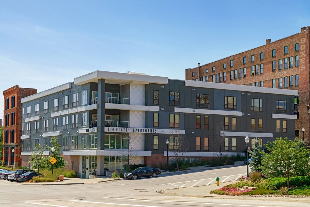 an apartment building on the corner of a city street