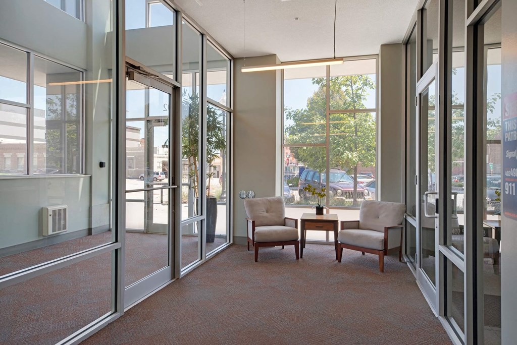 a conference room with a table and chairs and glass doors