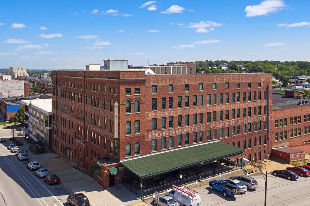 an aerial view of a large brick building in a city
