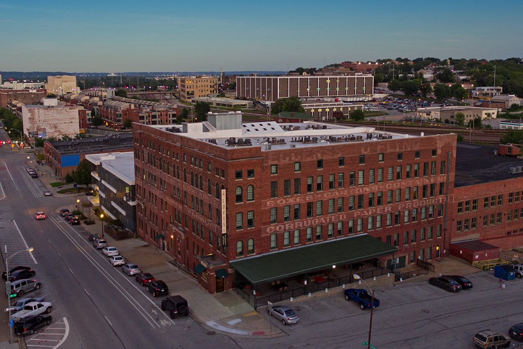 an aerial view of a large brick building in a city