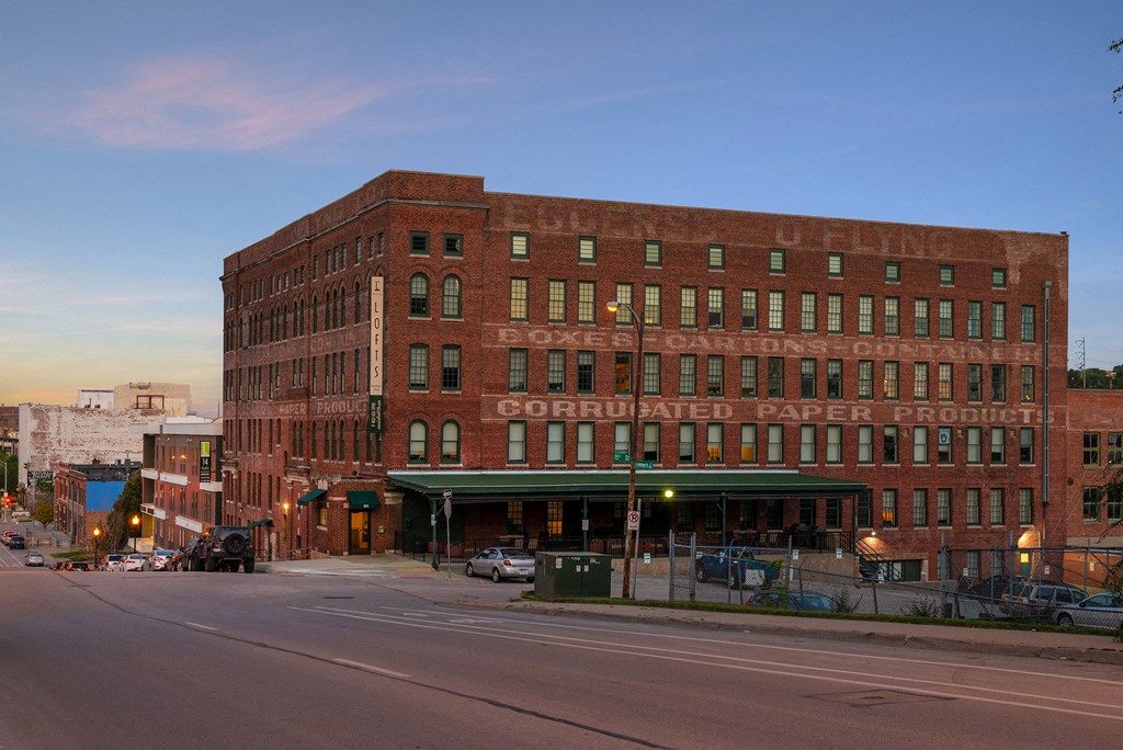 a large brick building on the corner of a city street