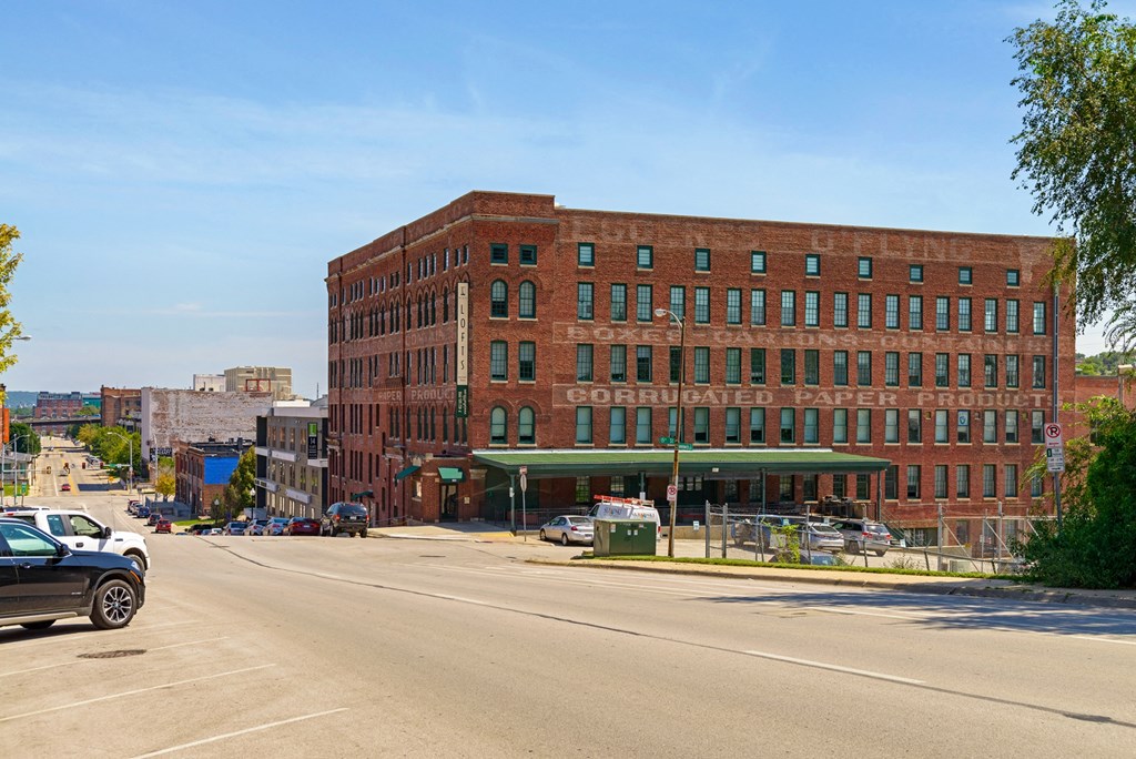 a large red brick building on the corner of a city street