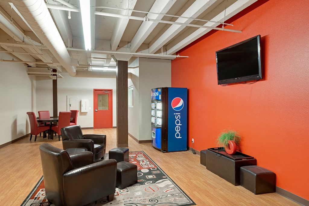 the lobby of a cola vending machine in a room with chairs