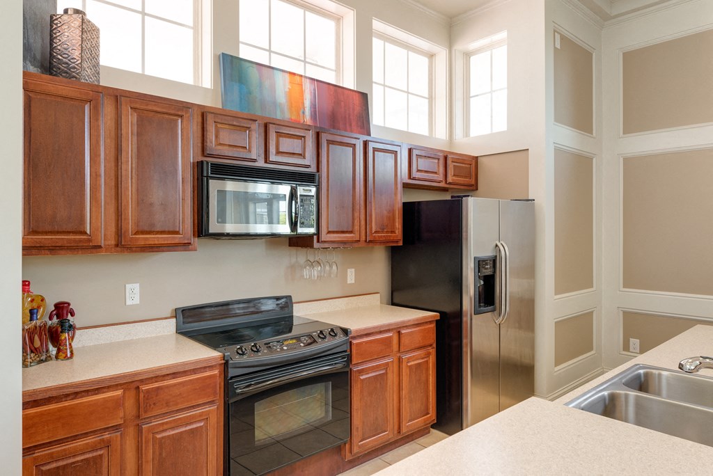 a kitchen with stainless steel appliances and wooden cabinets