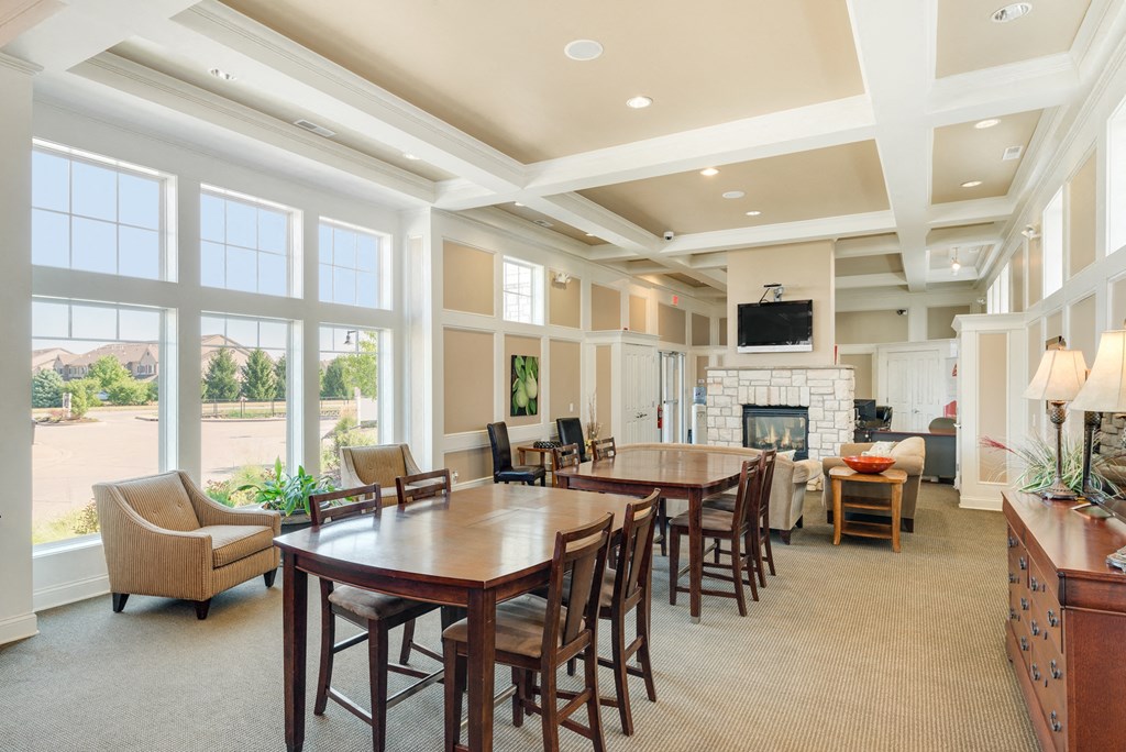 a large dining room with a table and chairs and a fireplace