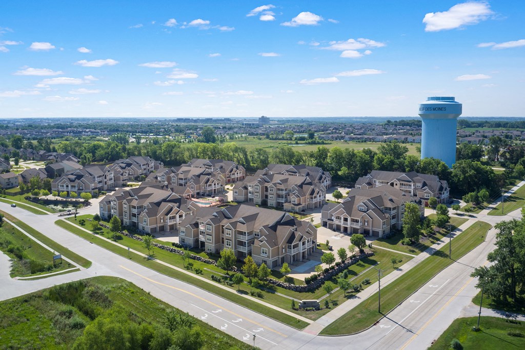 an aerial view of a large neighborhood with a water tower in the background