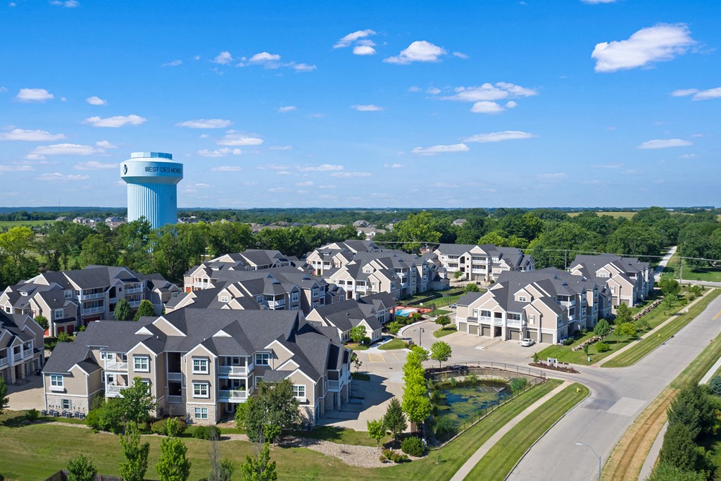 an aerial view of large houses with a water tower in the background