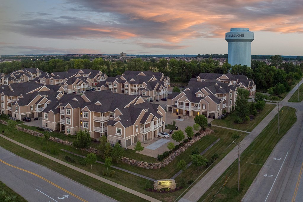 an aerial view of a neighborhood of houses with a water tower in the background